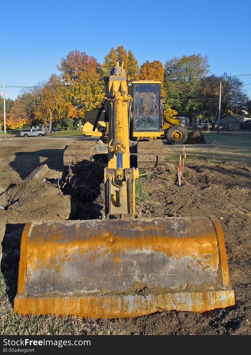 Old rusted excavator on a job site. Old rusted excavator on a job site