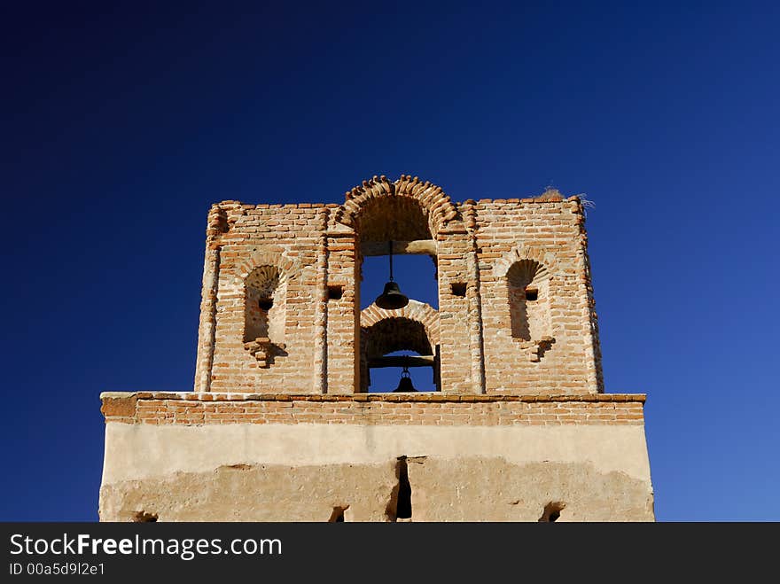 Tumacacori Mission Bell Tower against a blue sky in Arizona