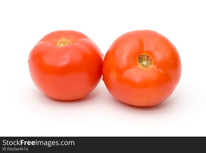 Two tomatoes on the white