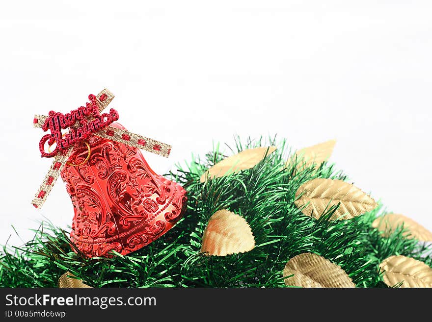 Red christmas bell with golden leaves and green ribbons over white background. Red christmas bell with golden leaves and green ribbons over white background