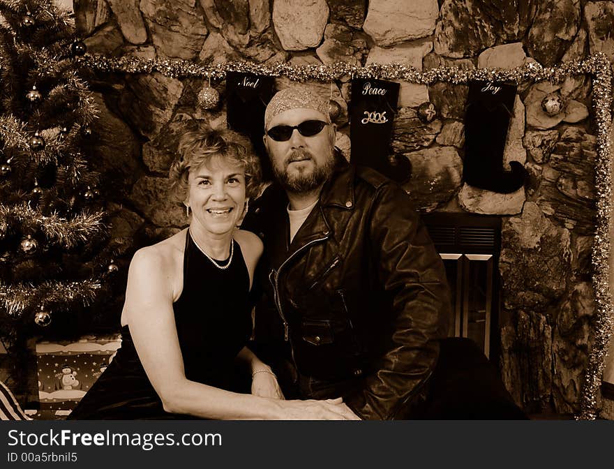 Biker in leathers with a woman in a long black dress. Biker in leathers with a woman in a long black dress