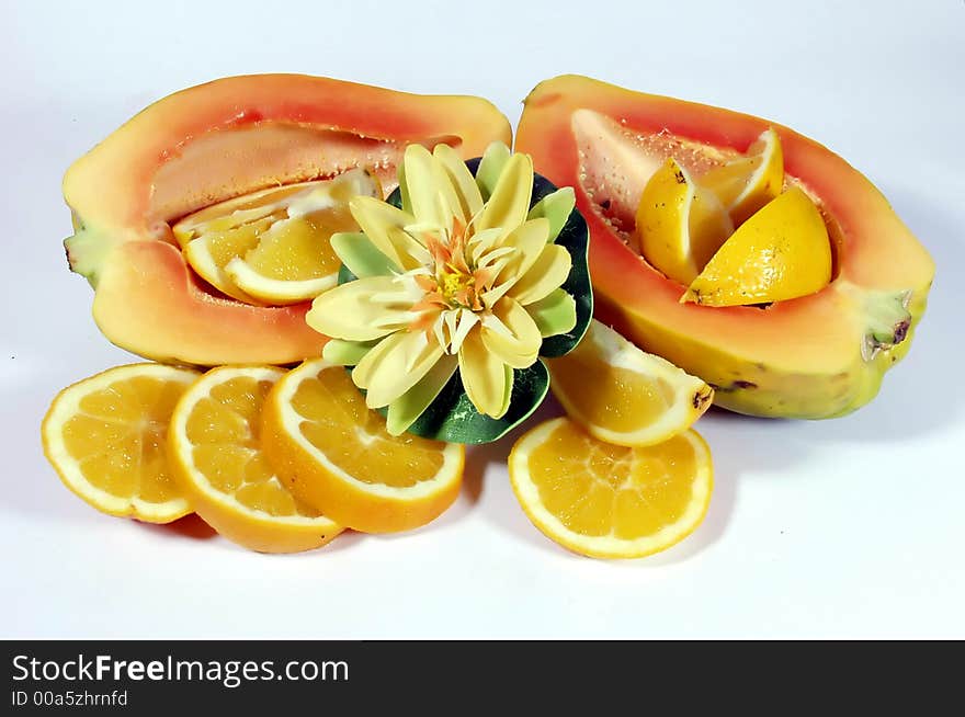 Fresh papaya and orange slices on white background. Fresh papaya and orange slices on white background