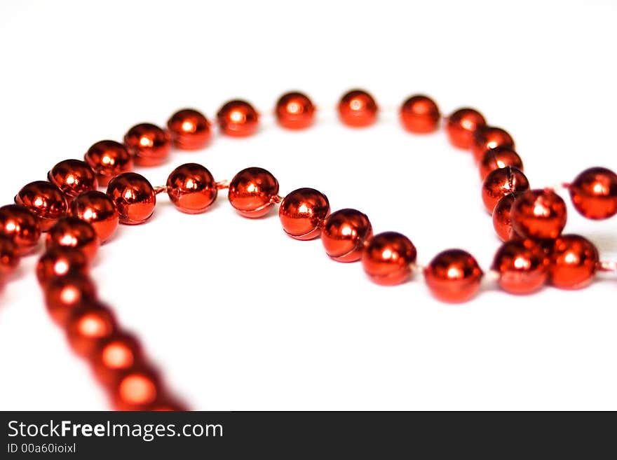 Red beads isolated on white in shape of heart