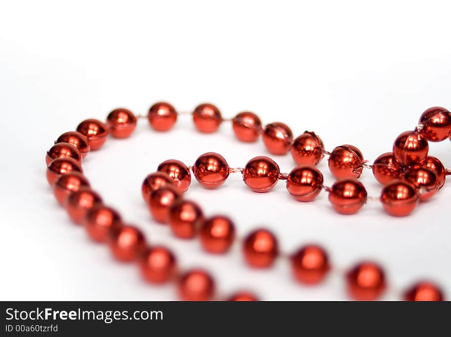 Red beads isolated on white in shape of heart