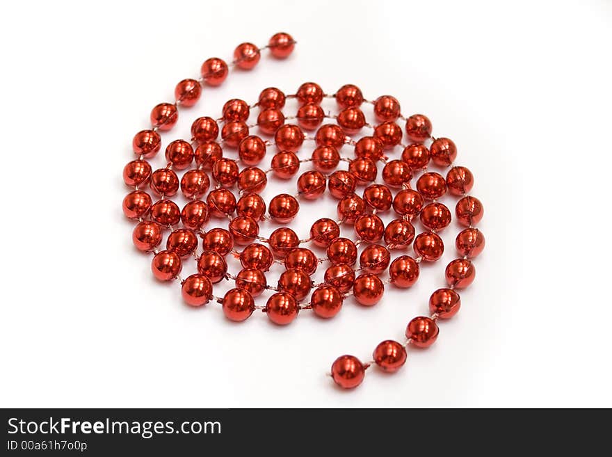 Arrangement of red beads on white background