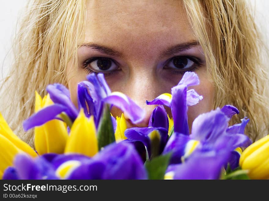 Blondgirl smelling flowers