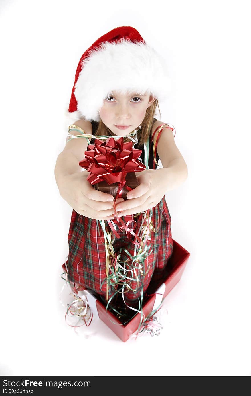 A young girl giving a gift box with a red bow, she is coming out of a gift box. A young girl giving a gift box with a red bow, she is coming out of a gift box