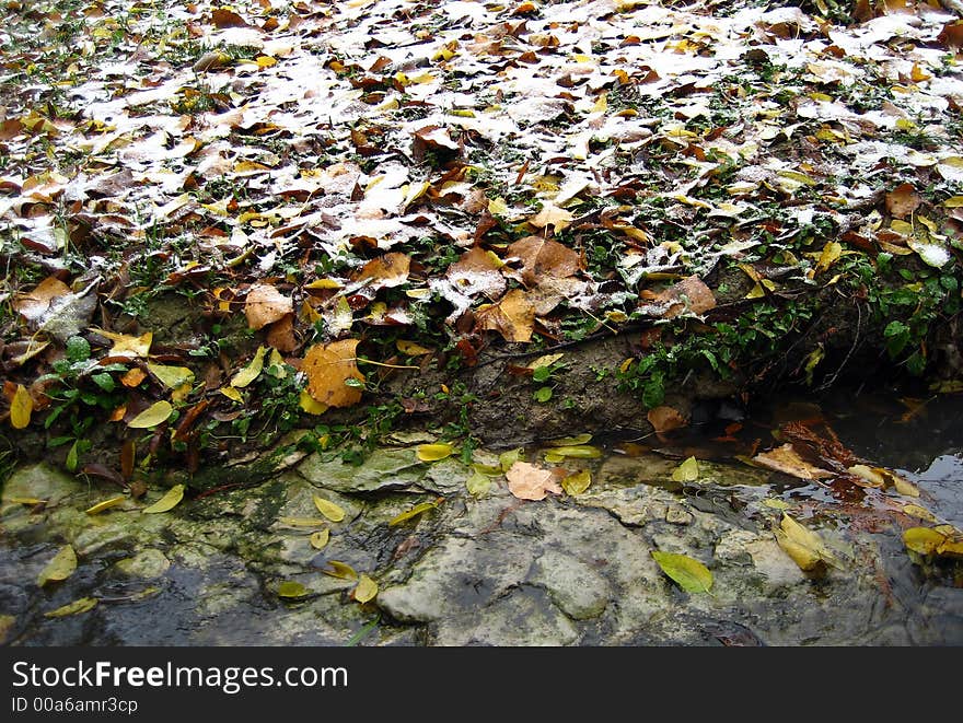 A stream with fresh snow next to it. A stream with fresh snow next to it