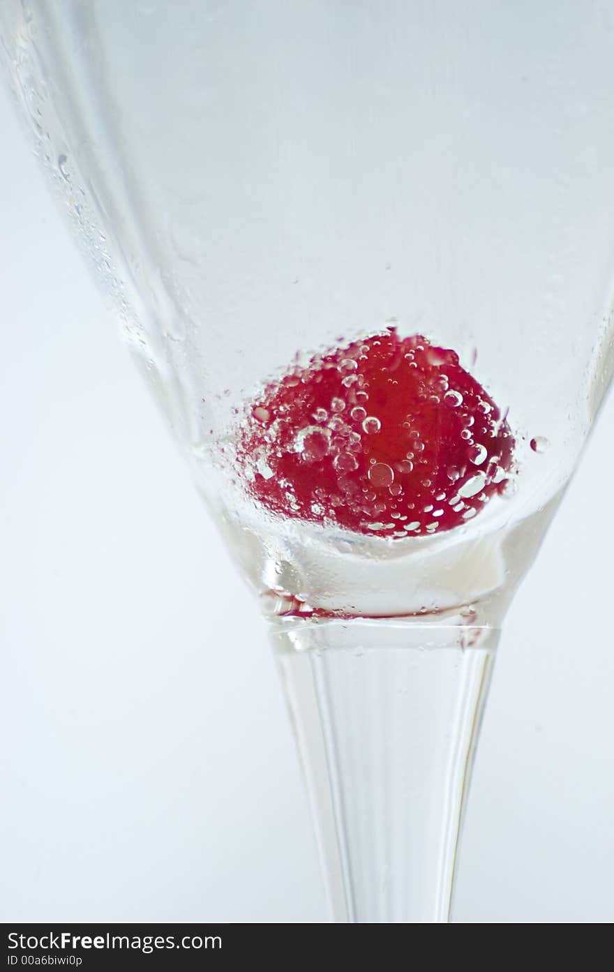 Glass of champagne with a cherry