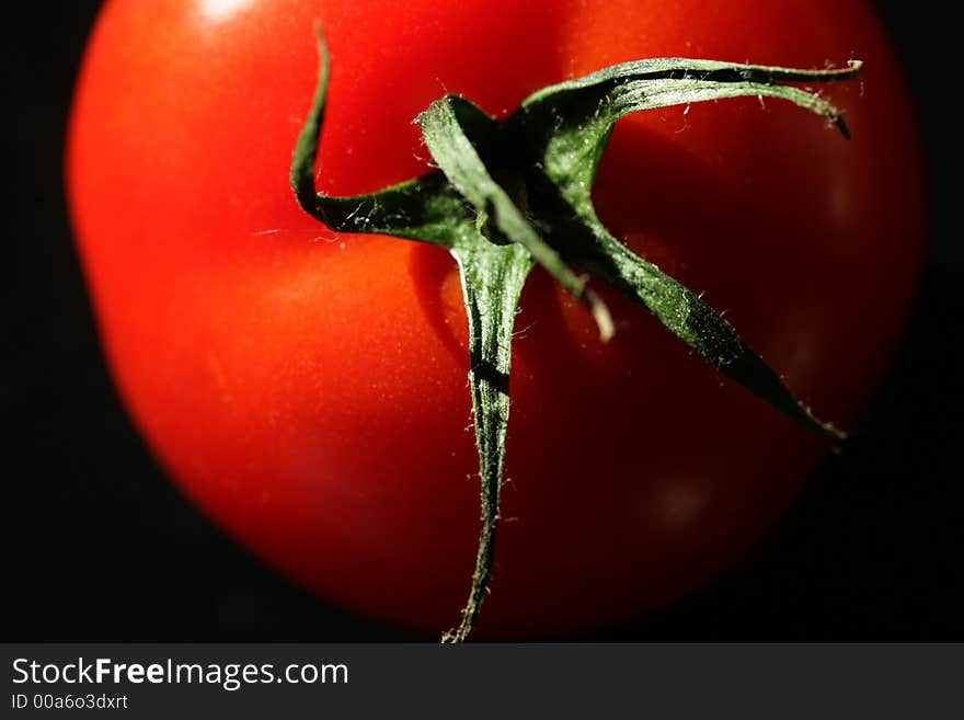 Tomato close up in natural light with dark background. Tomato close up in natural light with dark background