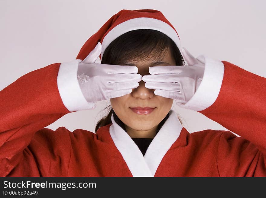 Asian girl showing See No Evil in Christmas Attire.