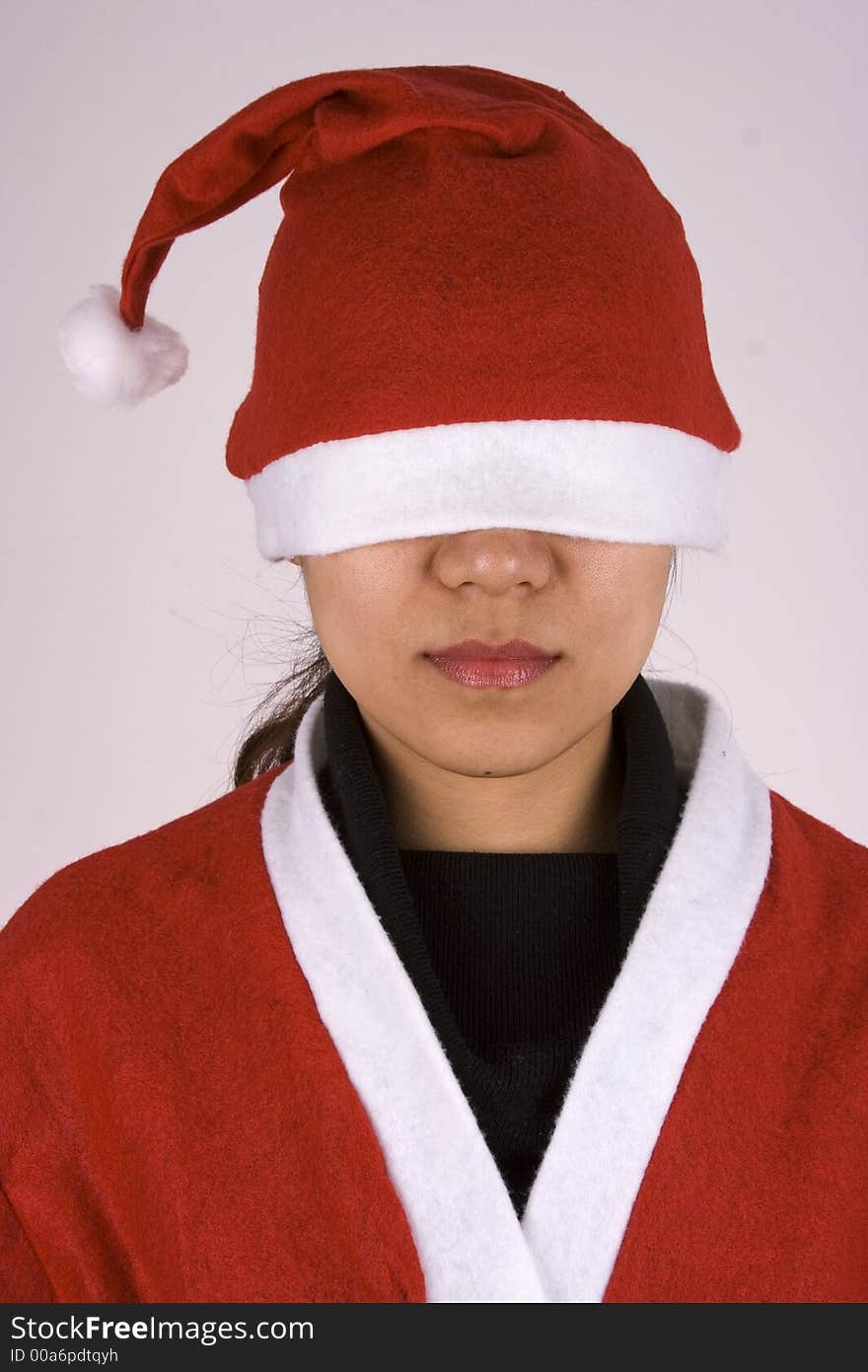 Asian girl showing See No Evil in Christmas Attire.