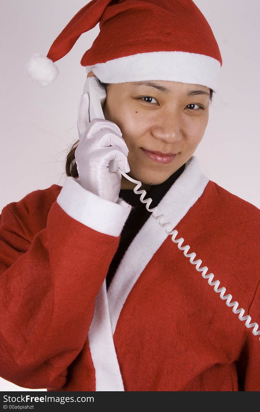 Asian female santa claus making a phone call. Asian female santa claus making a phone call.