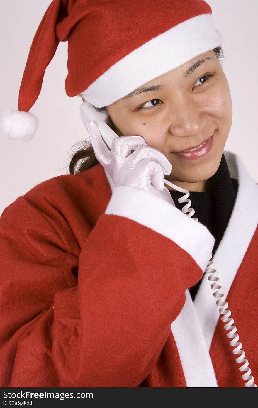 Asian female santa claus making a phone call. Asian female santa claus making a phone call.