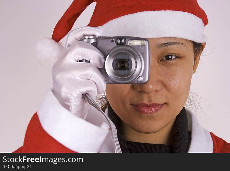 An Asian female santa claus with camera.