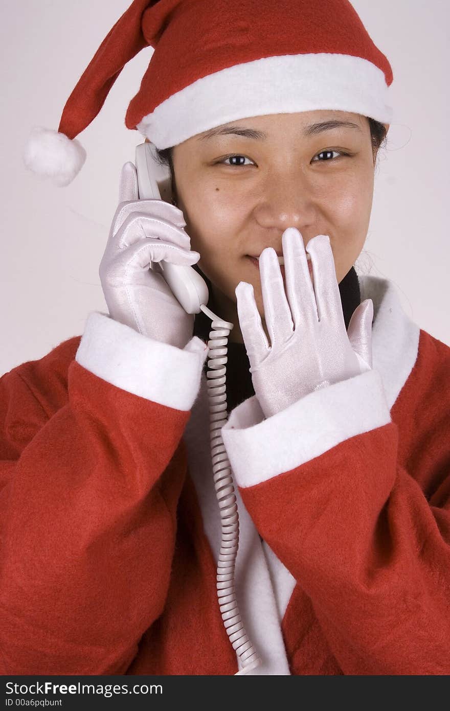 Asian female santa claus making a phone call. Asian female santa claus making a phone call.