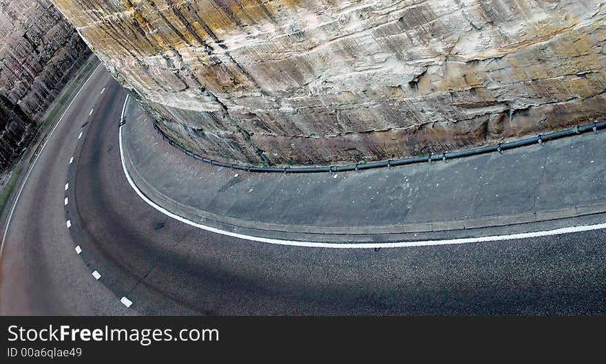 Road curve, stone walls on both sides