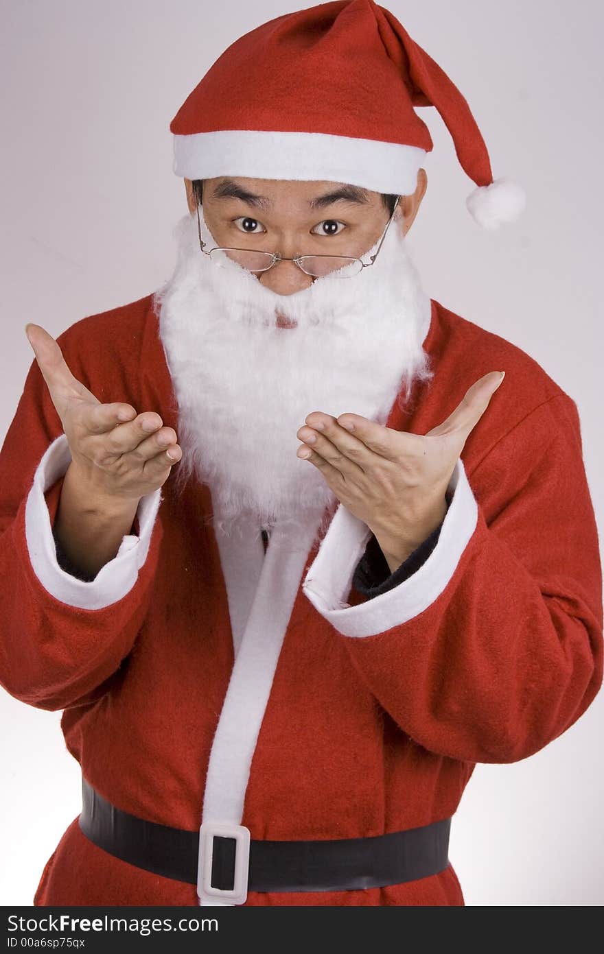 An Asian santa claus welcoming with both hands.