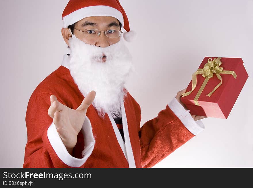 Asian Santa Claus holding a gift box. Asian Santa Claus holding a gift box.