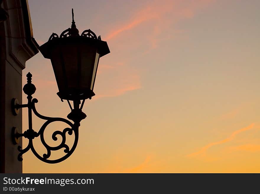 Old street lamp against sky background, silhouette