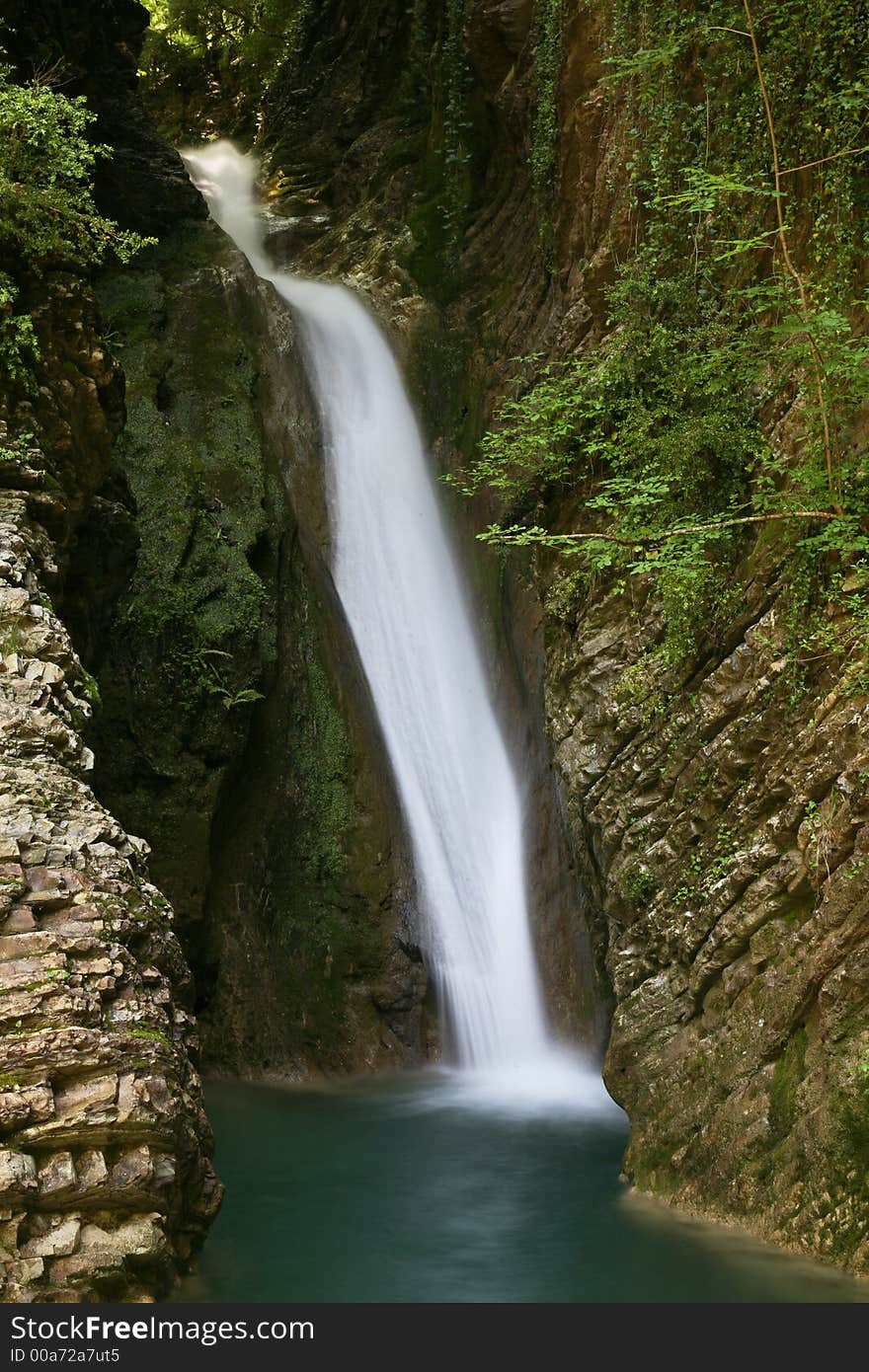 Waterfall in beautiful gorge between rocks. Waterfall in beautiful gorge between rocks