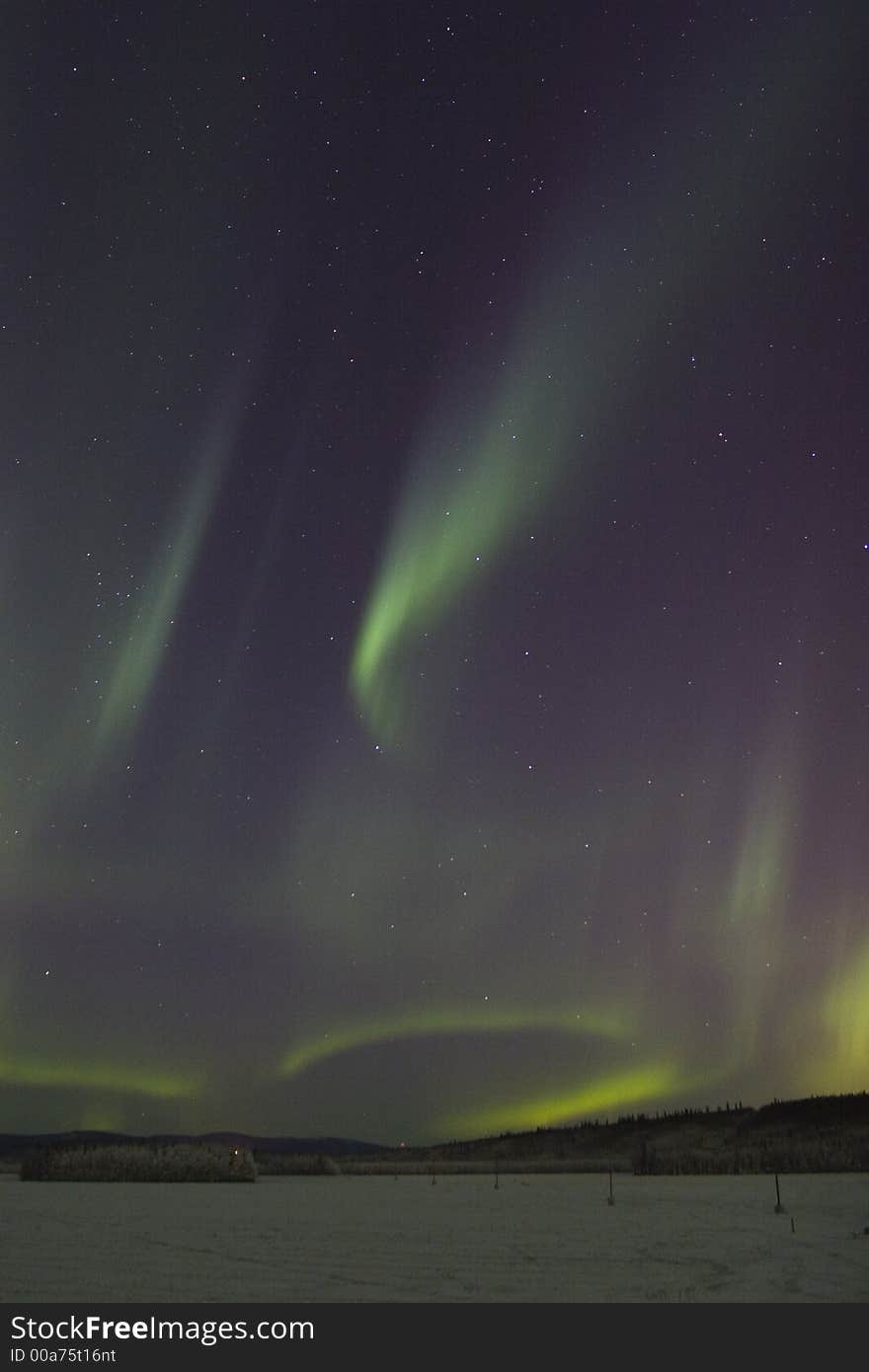 Sporadic displays of aurora borealis in dark night sky. Sporadic displays of aurora borealis in dark night sky