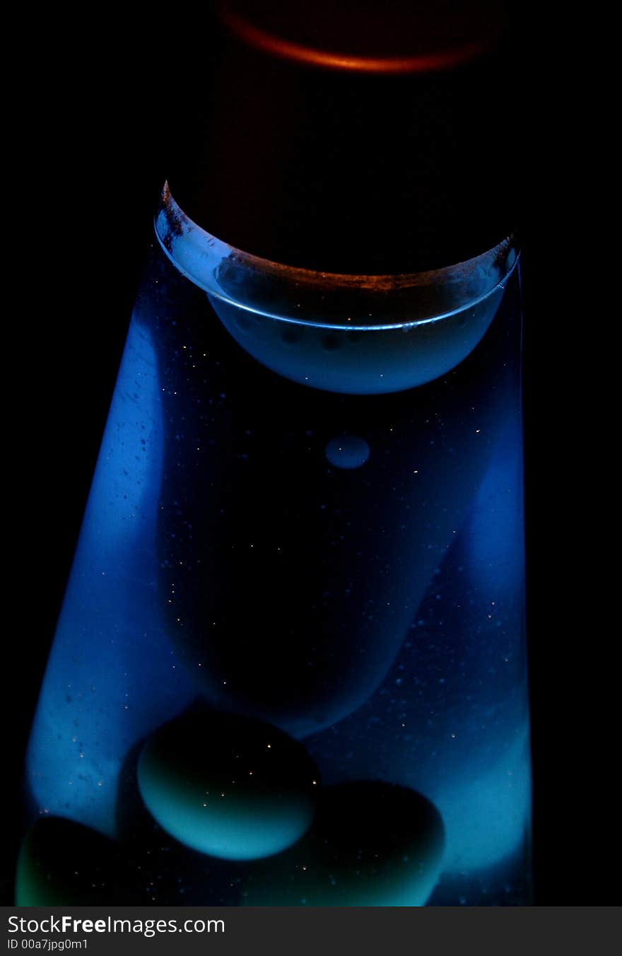 Blue lava lamp glowing in the dark