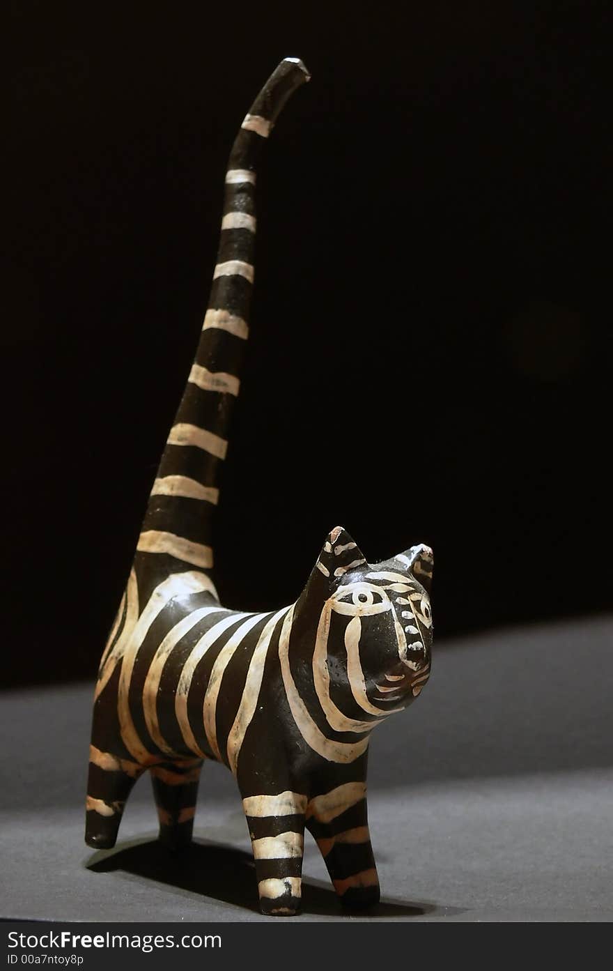 Hand made african wood cat with black background