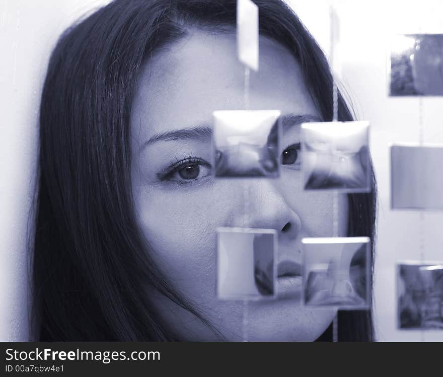 Studio shot of japanese woman with mirror hanging beads. Studio shot of japanese woman with mirror hanging beads