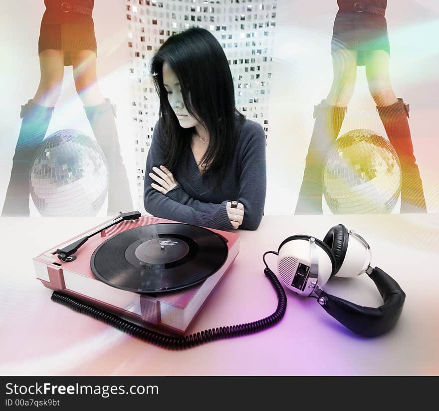 Studio shot of japanese woman looking at retro record player and headphones. Studio shot of japanese woman looking at retro record player and headphones