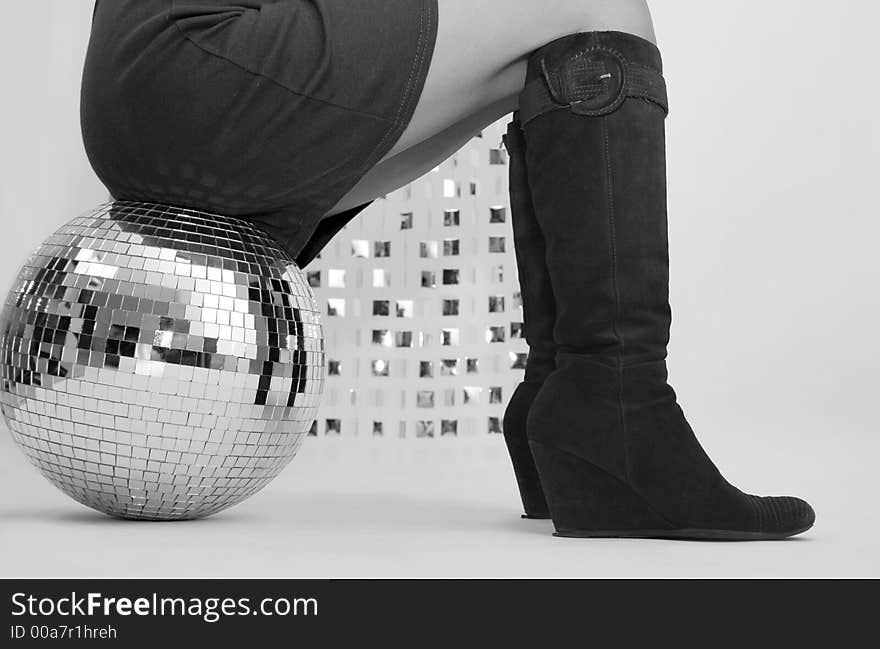 Studio shot of japanese woman sitting on glitterball. Studio shot of japanese woman sitting on glitterball