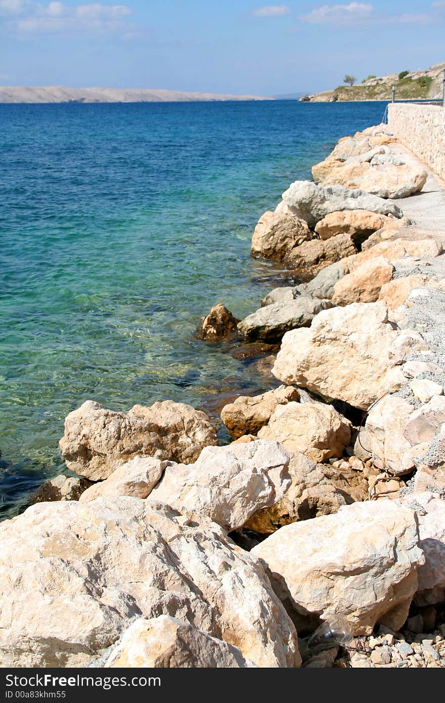 Stony coastline, colourful ocean, tranquil scenery