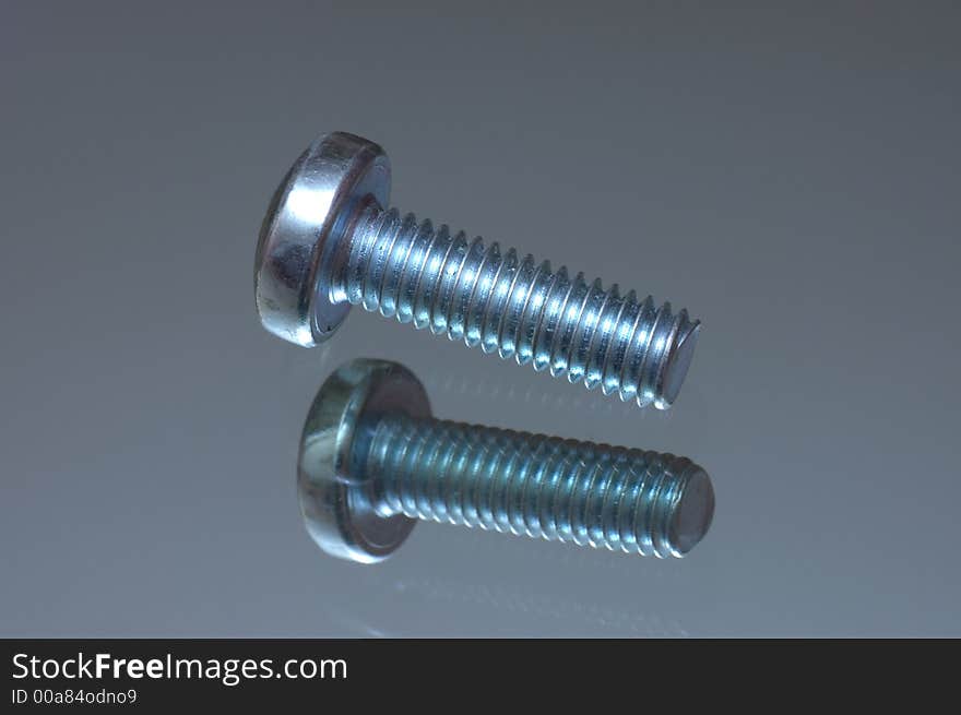 Screw on a reflecting surface close shot. Screw on a reflecting surface close shot