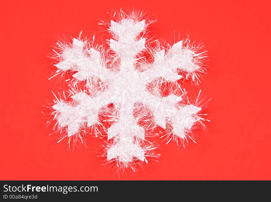 White Snowflake On Red Background