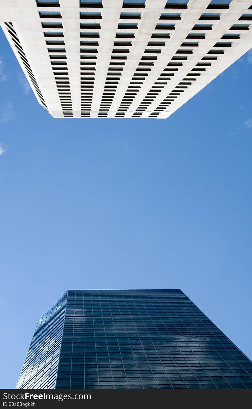 Blue sky reflected in a glass office building. Blue sky reflected in a glass office building