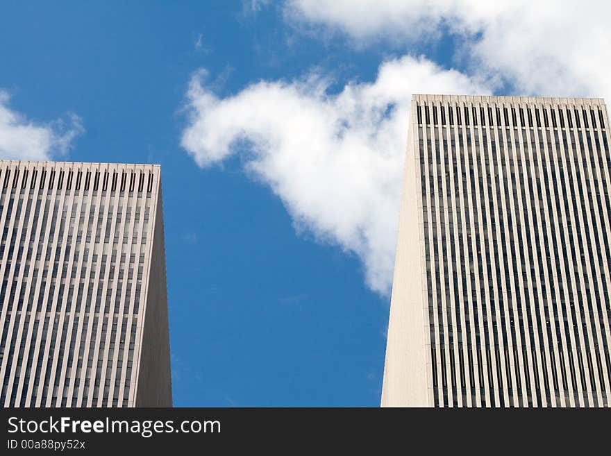 Modern skyscrapers against a bright blue sky