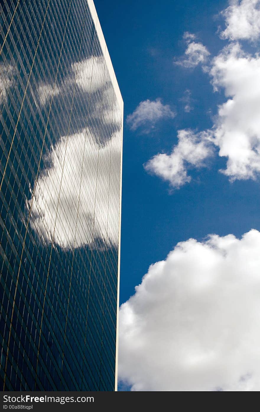 Blue sky reflected in a glass office building. Blue sky reflected in a glass office building