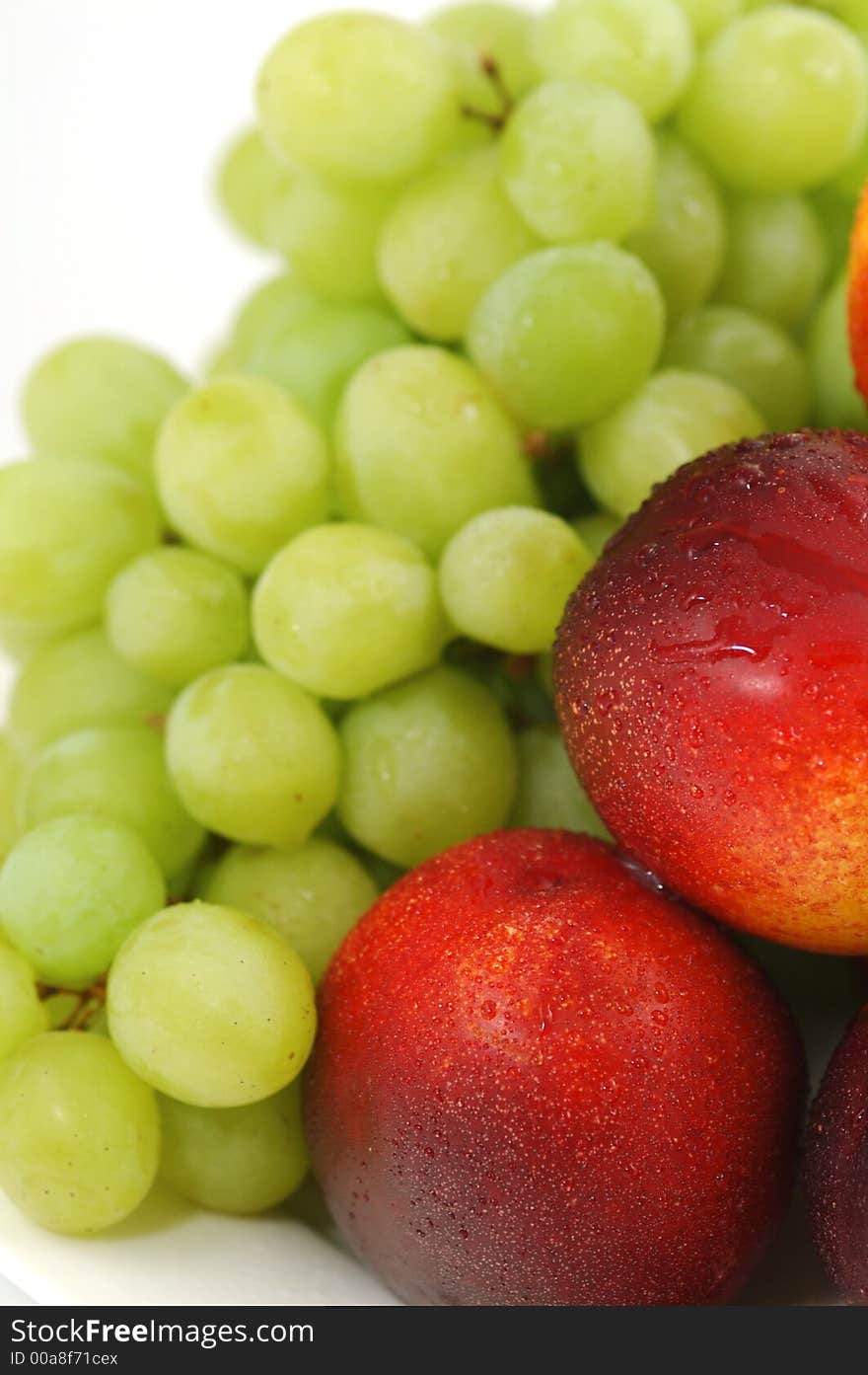 Colorful nectarines (peaches) and green grapes. Closeup. Colorful nectarines (peaches) and green grapes. Closeup.