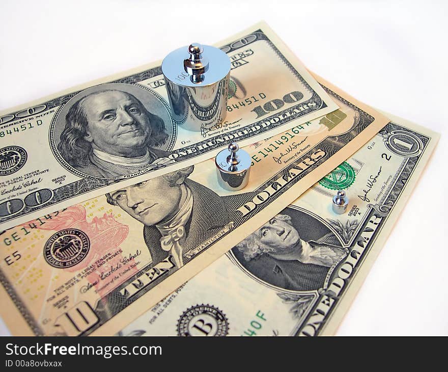 Dollars and weights on a white background. Dollars and weights on a white background