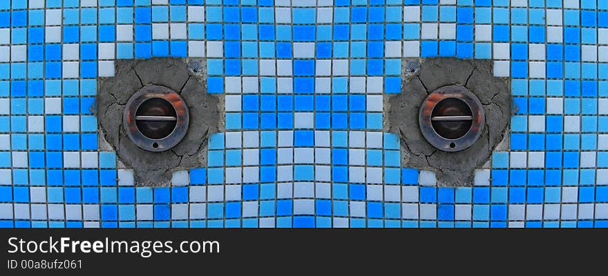 Cororful ceramic white and blue tiles between drainage holes. Cororful ceramic white and blue tiles between drainage holes