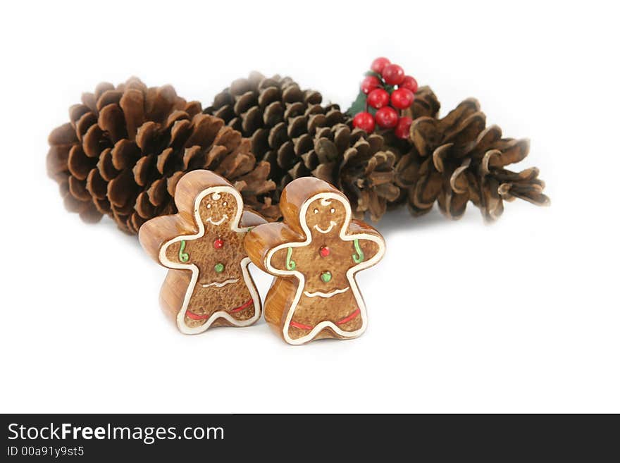 Gingerbread men and pine cones (focus on gingerbread men) - isolated