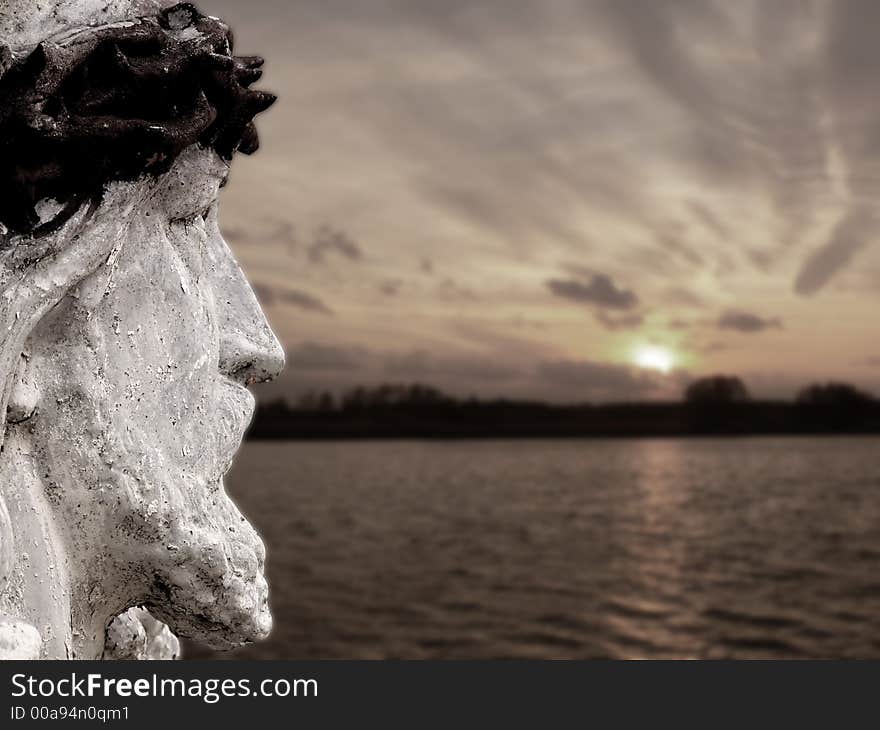 A statue of jesus against sunset landscape. A statue of jesus against sunset landscape