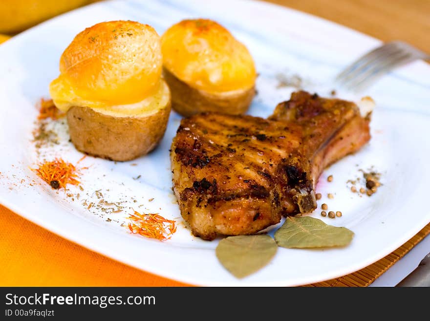 Baked Pork ribs and potato baked with cheese. Baked Pork ribs and potato baked with cheese