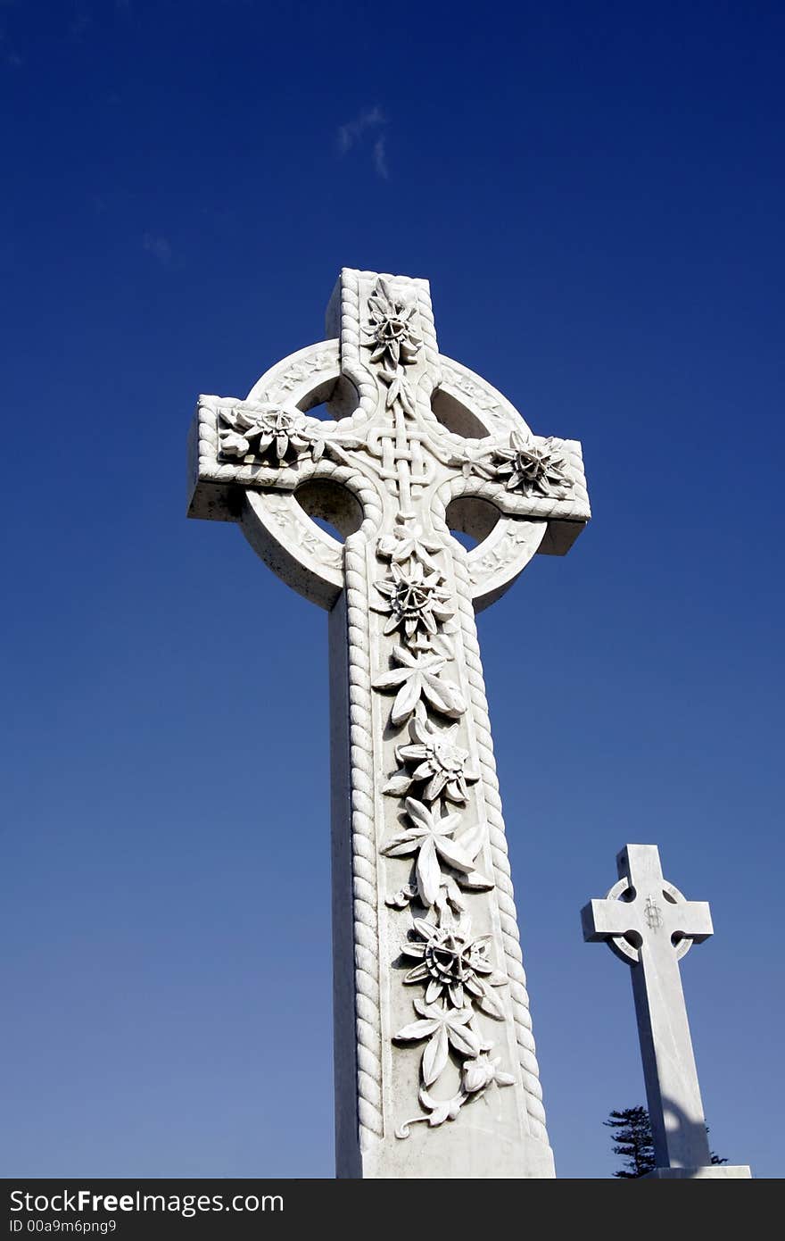 White Grave Stone Cross In Front Of Clear Blue Sky