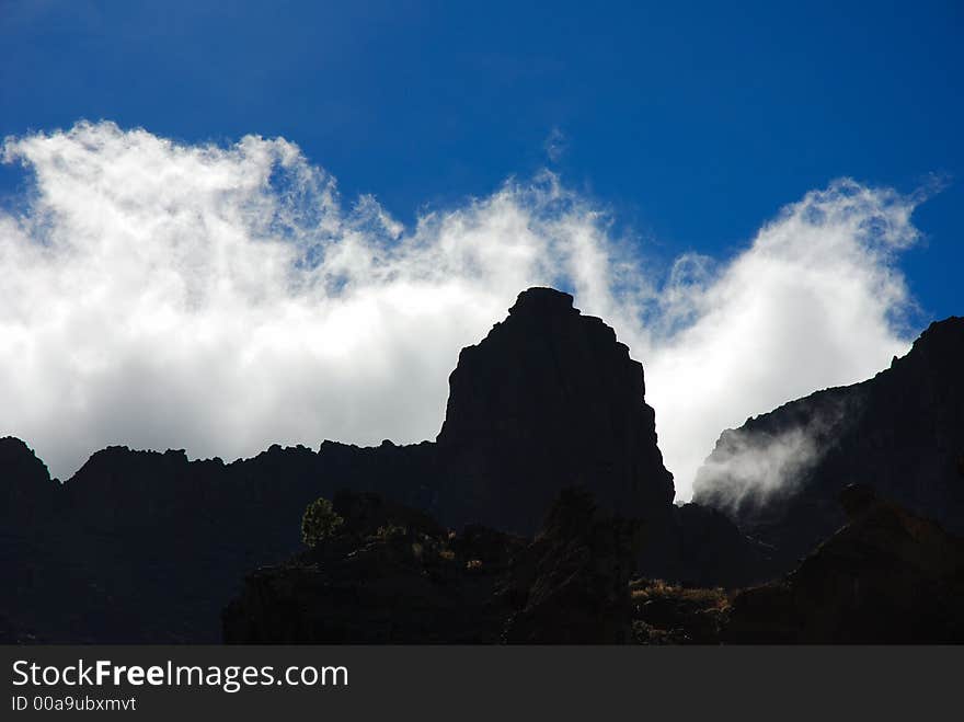 Stormclouds moving over the ridge of the caldera in Tenerife, Canary Islands. Back-lighting. Stormclouds moving over the ridge of the caldera in Tenerife, Canary Islands. Back-lighting.