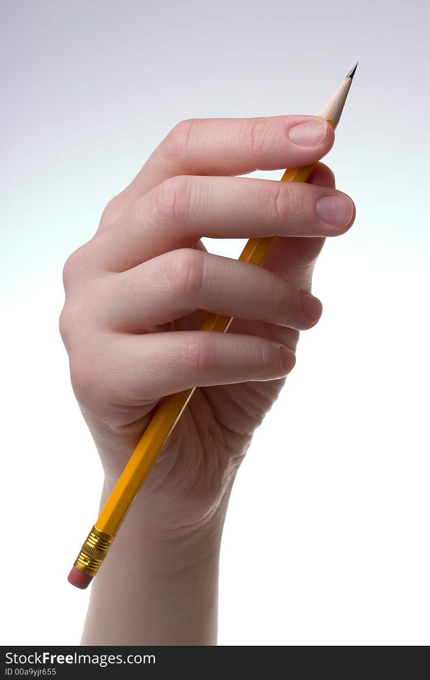 Hand with a pencil, on a blank white paper.