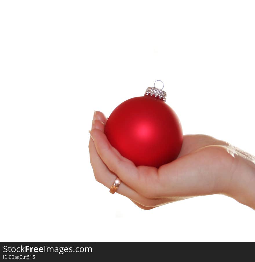 A white christmas background with a red christmas ball in the hand of a woman - very shiny. A white christmas background with a red christmas ball in the hand of a woman - very shiny