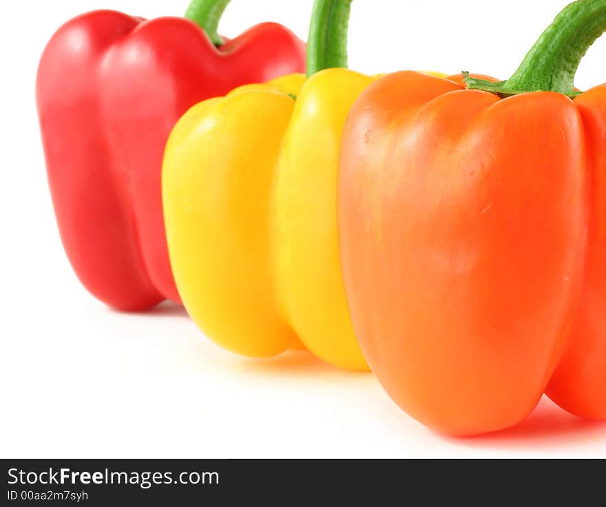 Close up of red, yellow and orange peppers isolated on white. Close up of red, yellow and orange peppers isolated on white