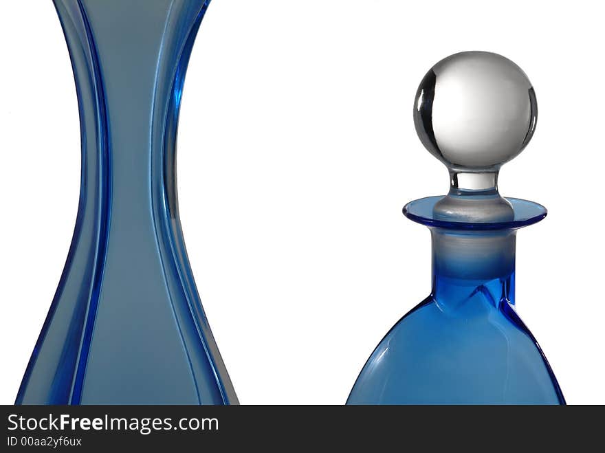 Beautiful blue bottles in glass on white