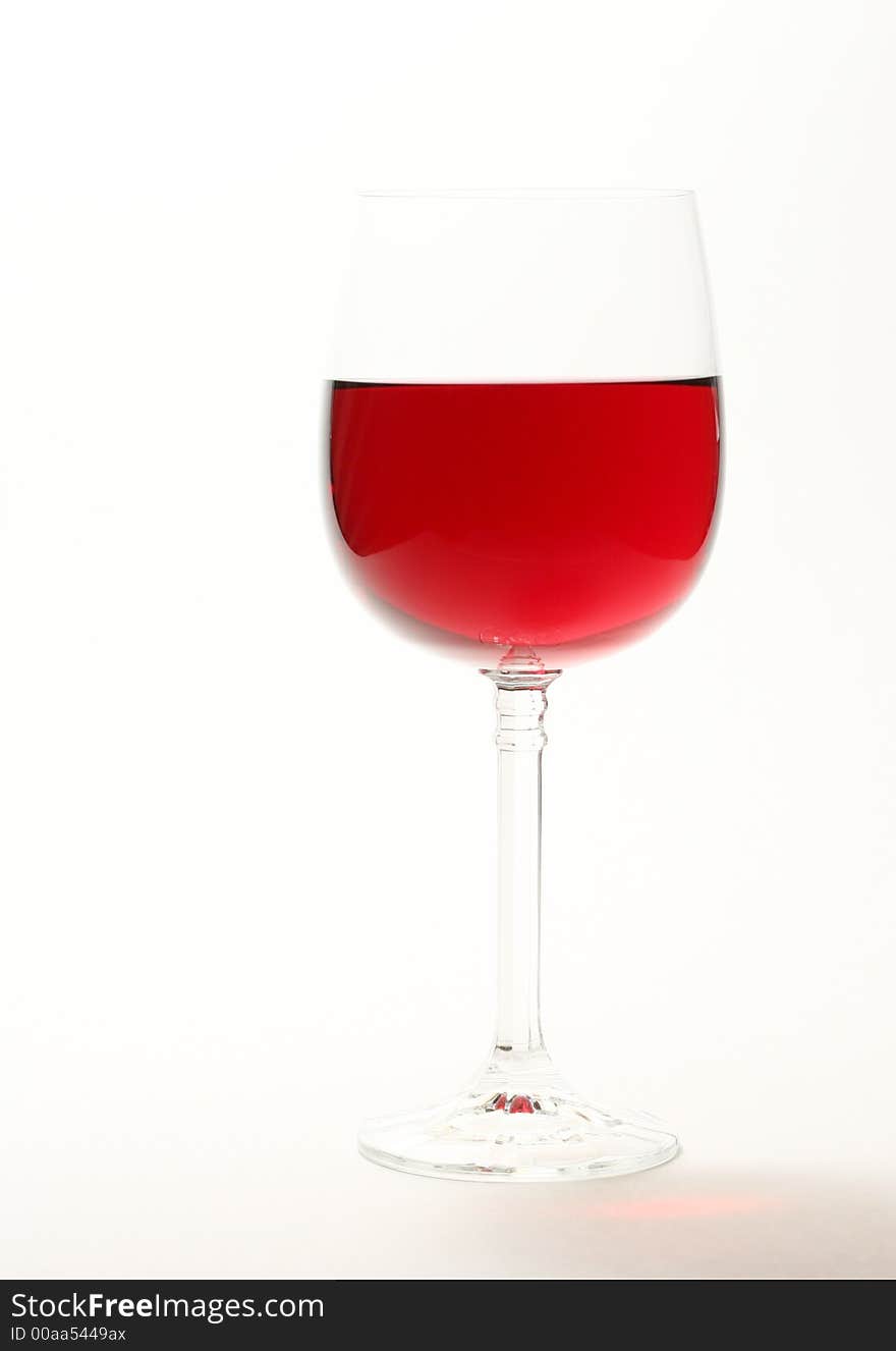 High key image of red wine in a glass isolated on white. High key image of red wine in a glass isolated on white